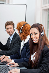Image showing friendly callcenter agent operator with headset telephone 