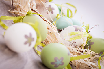 Image showing Colourful green Easter eggs in straw