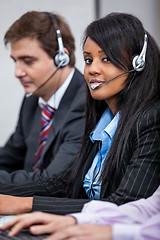 Image showing friendly callcenter agent operator with headset telephone 