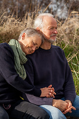 Image showing happy senior couple relaxing together in the sunshine