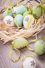 Image showing Colourful green Easter eggs in straw