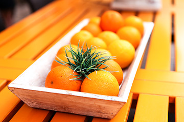 Image showing fresh orange fruits decorative on table in summer