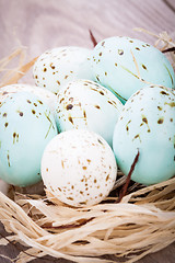 Image showing Three natural blue Easter eggs in a basket