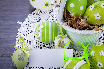 Image showing Colourful green Easter eggs in straw