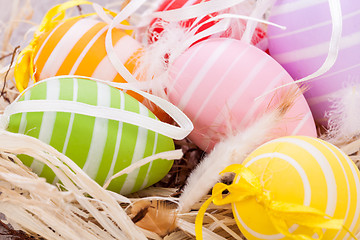 Image showing colorful easter egg decoration on wooden background