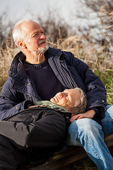 Image showing happy senior couple relaxing together in the sunshine