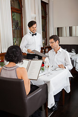 Image showing young smiling couple at the restaurant 