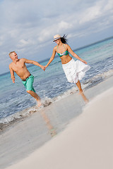 Image showing young happy couple walking on beach sunset holiday