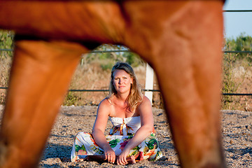 Image showing young woman training horse outside in summer