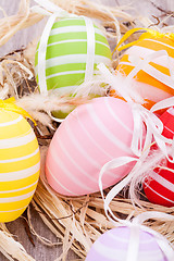 Image showing colorful easter egg decoration on wooden background