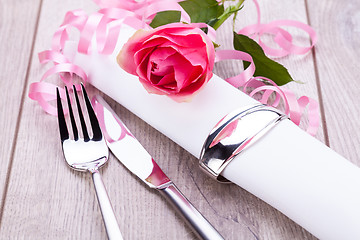 Image showing Table setting with a single pink rose