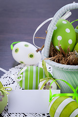 Image showing Colourful green Easter eggs in straw