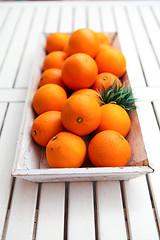 Image showing fresh orange fruits decorative on table in summer