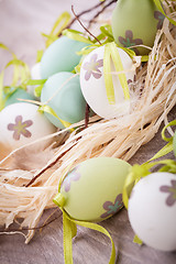 Image showing Colourful green Easter eggs in straw