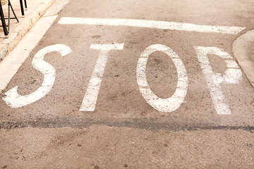 Image showing stop painted on asphalt outdoor 