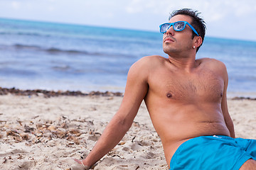 Image showing attractive young athletic man on the beach