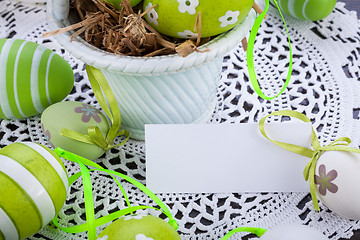 Image showing Colourful green Easter eggs in straw