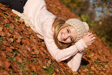 Image showing young smiling woman with hat and scarf outdoor in autumn