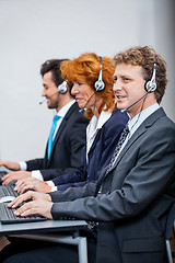 Image showing friendly callcenter agent operator with headset telephone 