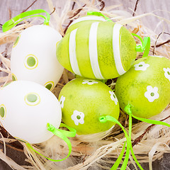 Image showing Colourful green Easter eggs in straw