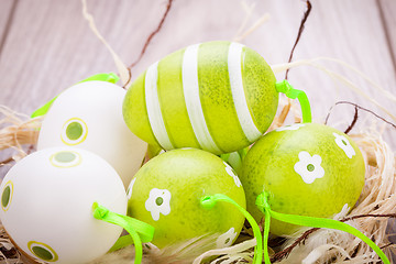 Image showing Colourful green Easter eggs in straw