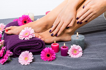 Image showing Bare feet of a woman surrounded by flowers