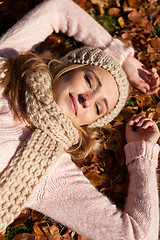 Image showing young smiling woman with hat and scarf outdoor in autumn