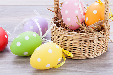 Image showing colorful easter egg decoration on wooden background