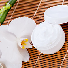 Image showing cosmetic face cream on wooden background 