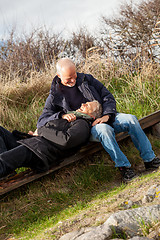 Image showing happy senior couple relaxing together in the sunshine