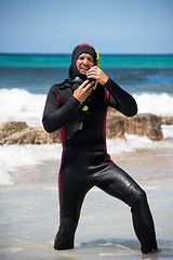 Image showing male diver with diving suit snorkel mask fins on the beach