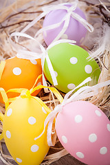 Image showing colorful easter egg decoration on wooden background