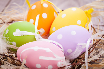 Image showing colorful easter egg decoration on wooden background