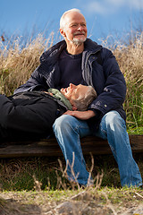 Image showing happy senior couple relaxing together in the sunshine