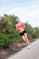 Image showing young athletic woman runner jogger outdoor