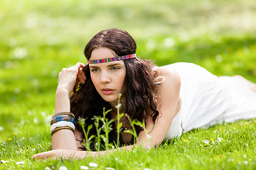 Image showing Pretty young woman in a headband daydreaming