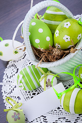 Image showing Colourful green Easter eggs in straw