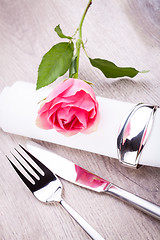 Image showing Table setting with a single pink rose