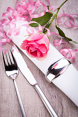 Image showing Table setting with a single pink rose