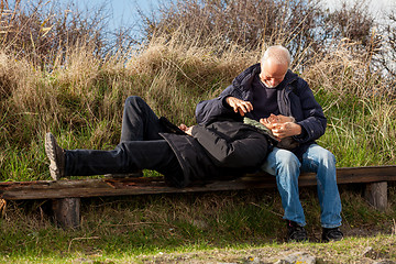 Image showing happy senior couple relaxing together in the sunshine