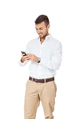 Image showing Handsome man reading a message on his mobile