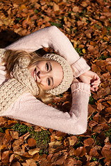 Image showing young smiling woman with hat and scarf outdoor in autumn