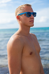 Image showing attractive young athletic man on the beach