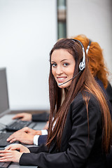 Image showing friendly callcenter agent operator with headset telephone 