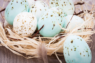 Image showing Three natural blue Easter eggs in a basket