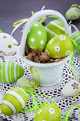 Image showing Colourful green Easter eggs in straw