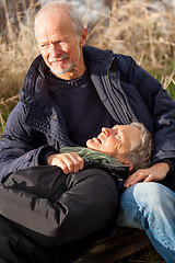 Image showing happy senior couple relaxing together in the sunshine