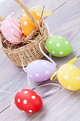 Image showing colorful easter egg decoration on wooden background