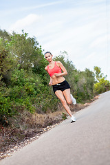 Image showing young athletic woman runner jogger outdoor
