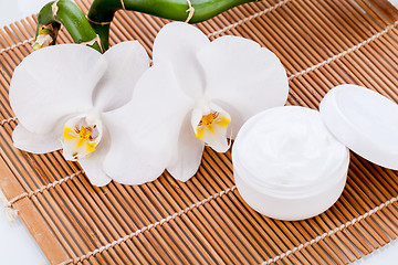 Image showing cosmetic face cream on wooden background 